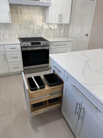 a kitchen with granite countertop a stove and a sink