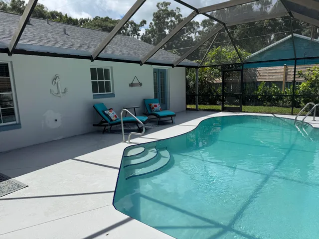 an outdoor space with swimming pool and furniture