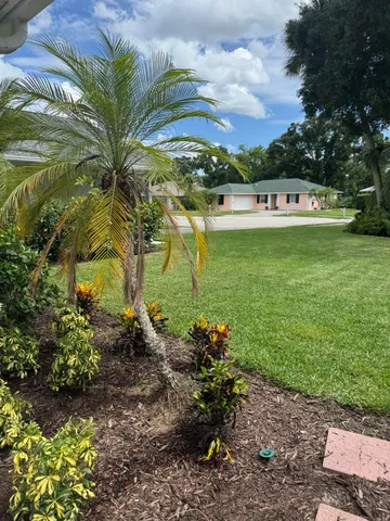 a sign that is sitting in front of flowers