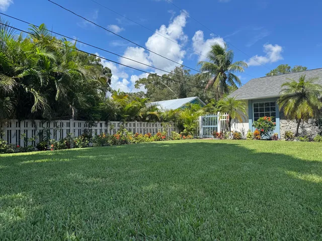 a view of a backyard with sitting area