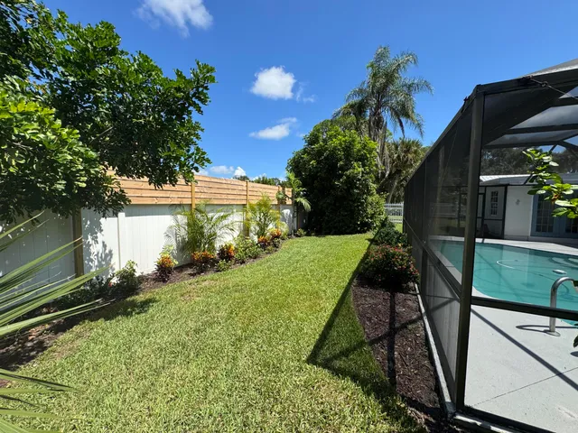 a view of a backyard with pathway