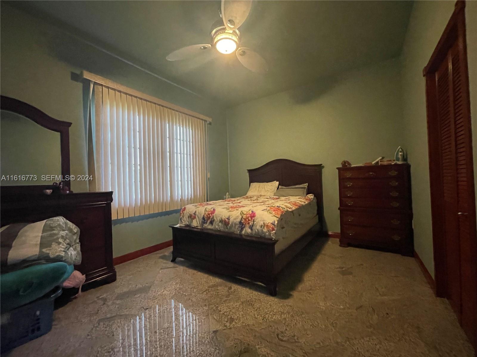 31002 Southwest 212th Avenue Homestead, FL 33030 - Photo 13 of 30 a spacious bedroom with a bed and a couch