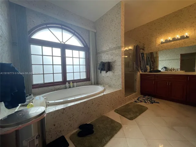 a spacious bathroom with a sink and a bathtub