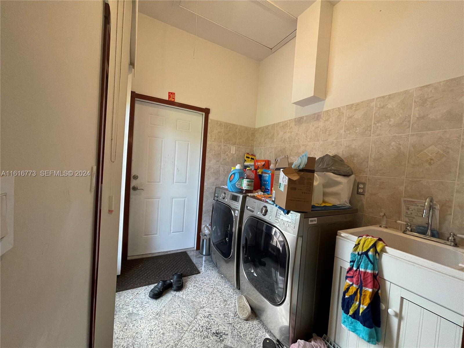 31002 Southwest 212th Avenue Homestead, FL 33030 - Photo 18 of 30 a utility room with dryer and washer
