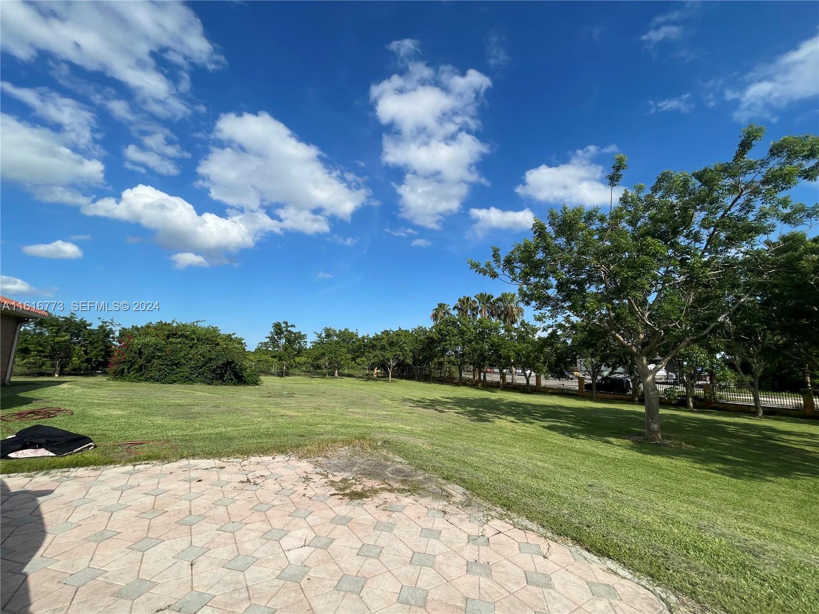31002 Southwest 212th Avenue Homestead, FL 33030 - Photo 25 of 30 a view of a golf course with a garden