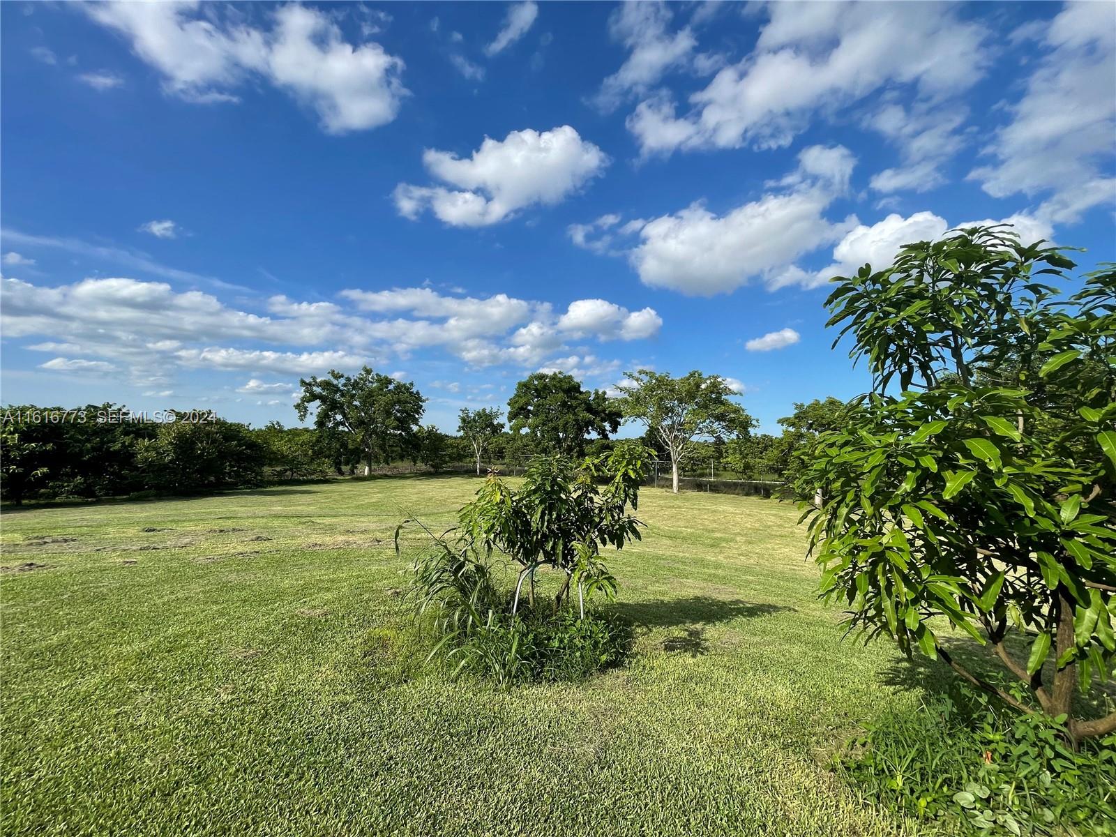 31002 Southwest 212th Avenue Homestead, FL 33030 - Photo 28 of 30 a view of a lake with a yard