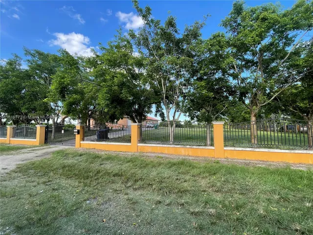 a swimming pool with an outdoor space and seating area