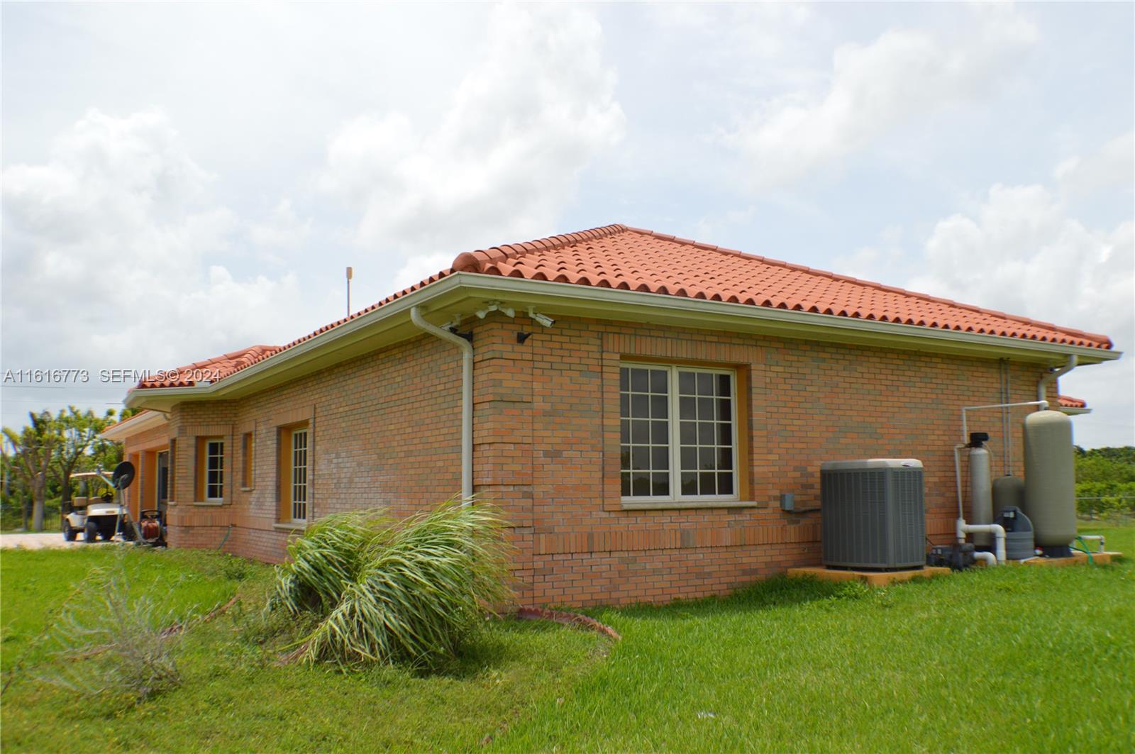 31002 Southwest 212th Avenue Homestead, FL 33030 - Photo 3 of 30 a front view of a house with a garden