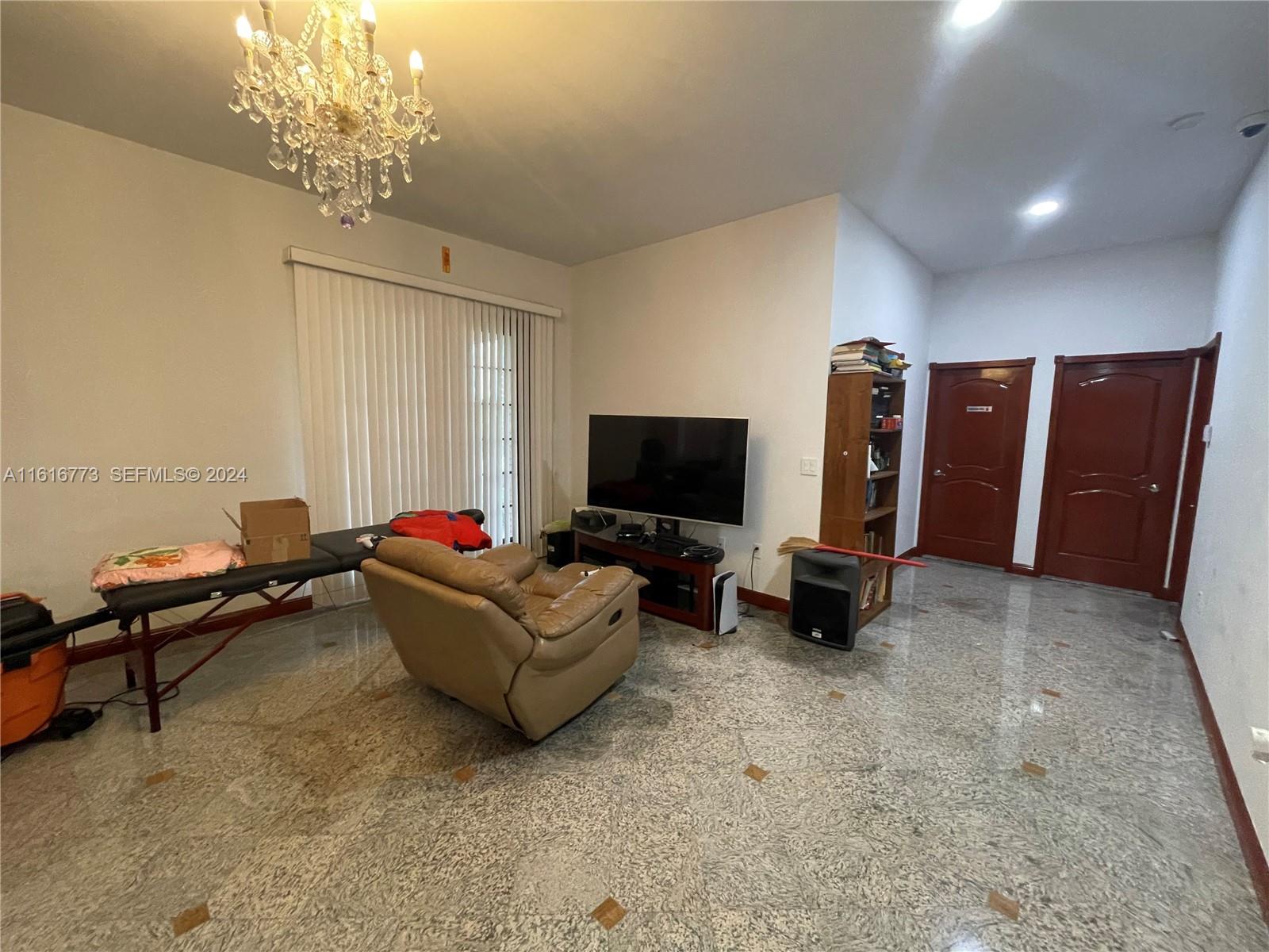 31002 Southwest 212th Avenue Homestead, FL 33030 - Photo 7 of 30 a living room with furniture and a flat screen tv