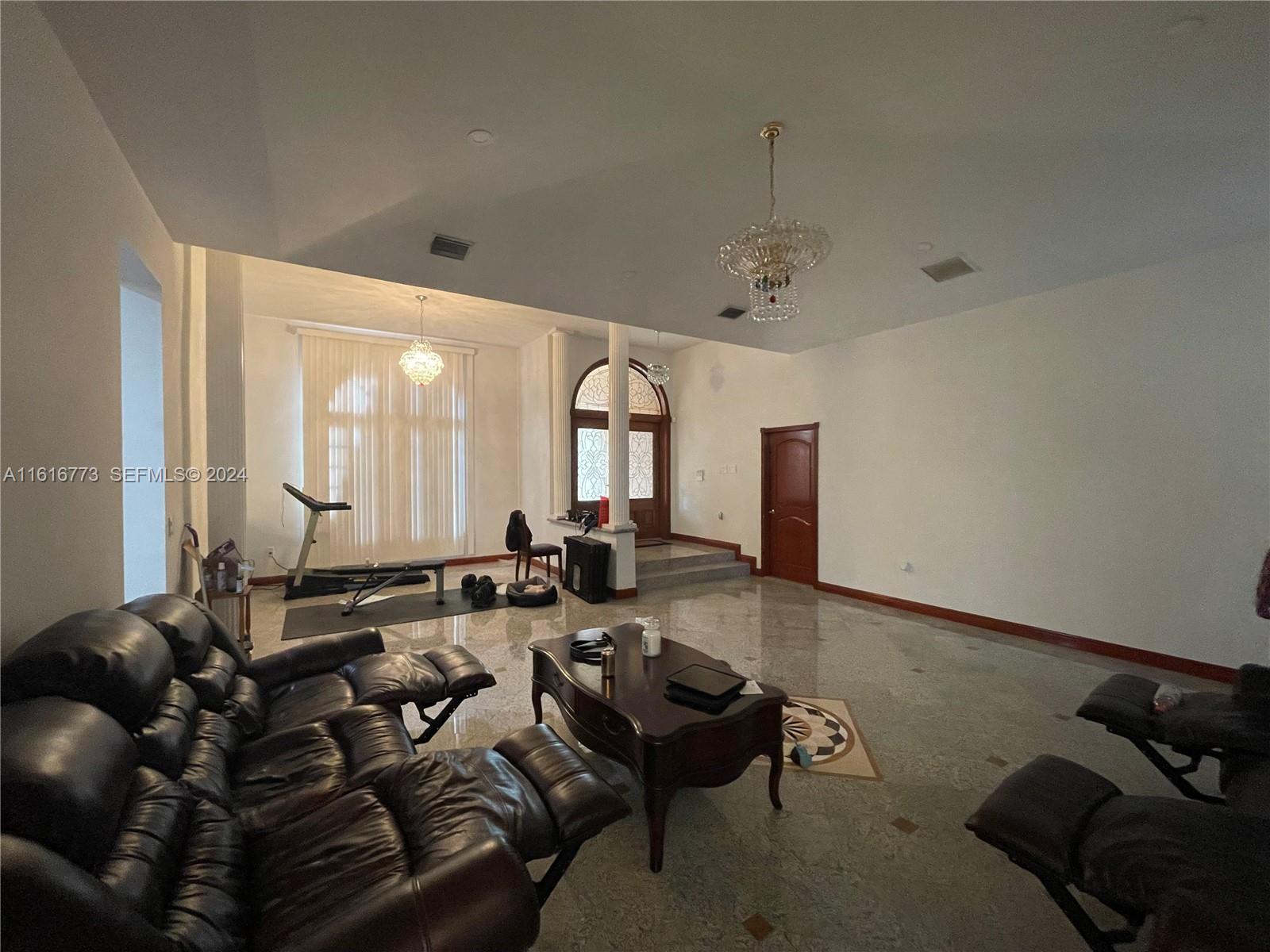 31002 Southwest 212th Avenue Homestead, FL 33030 - Photo 8 of 30 a living room with furniture and large windows