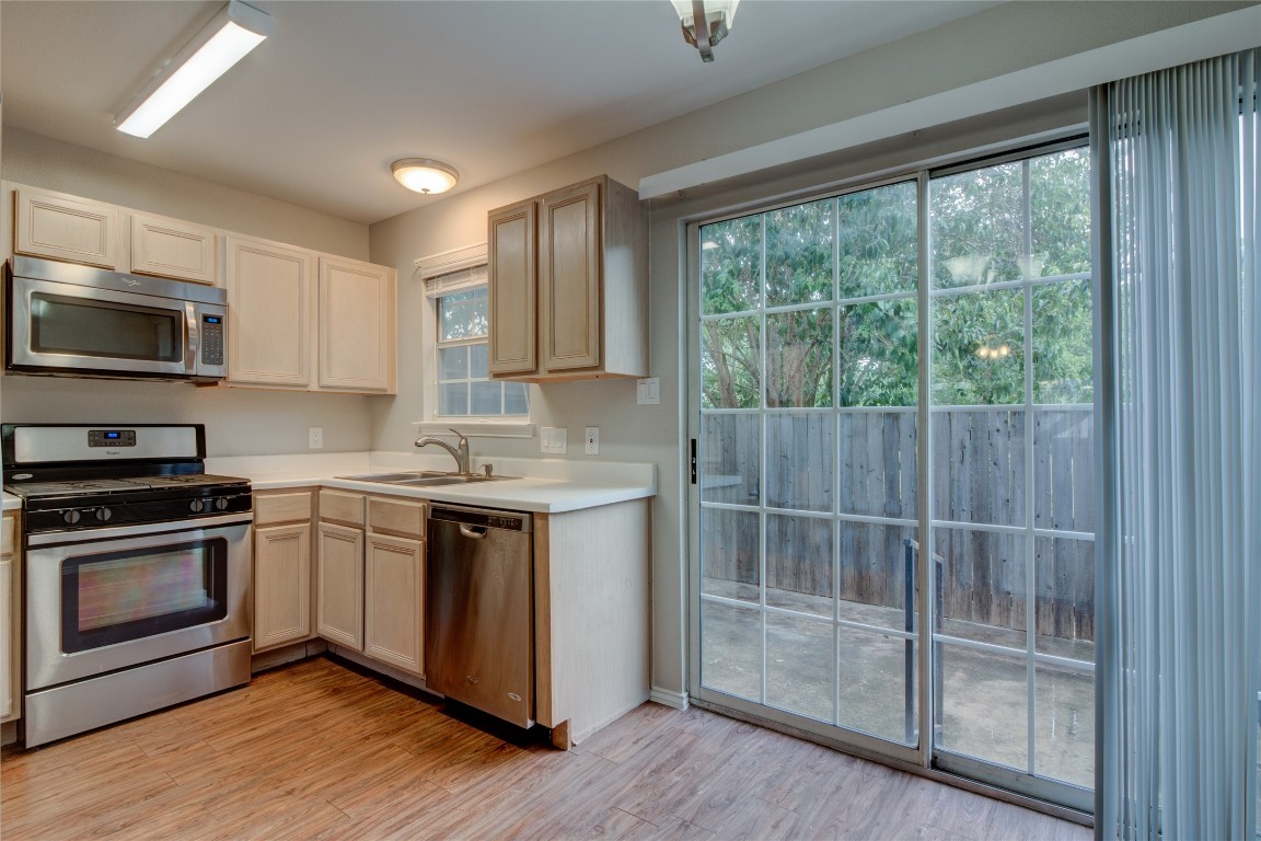 202 South College Street, Unit 8 Georgetown, TX 78626 - Photo 17 of 40 Kitchen featuring stainless steel appliances, light countertops, and light wood-type flooring