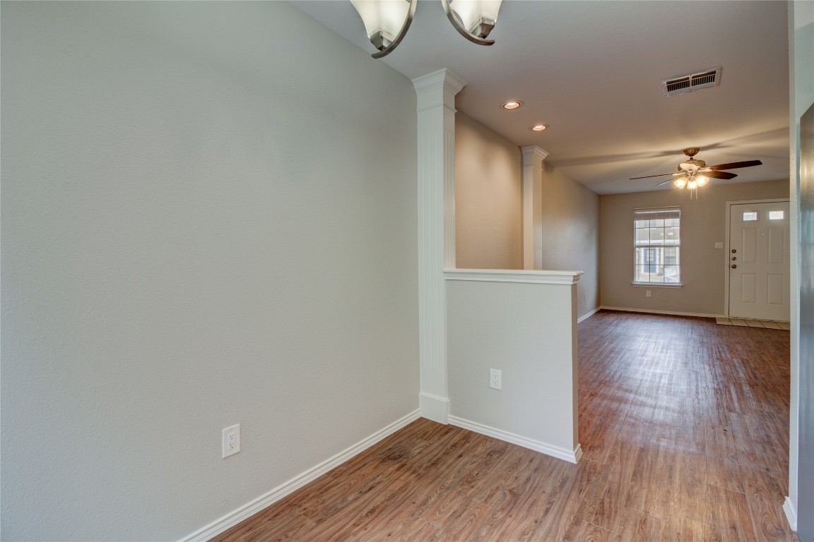 202 South College Street, Unit 8 Georgetown, TX 78626 - Photo 20 of 40 Spare room featuring wood finished floors, a ceiling fan, decorative columns, and recessed lighting