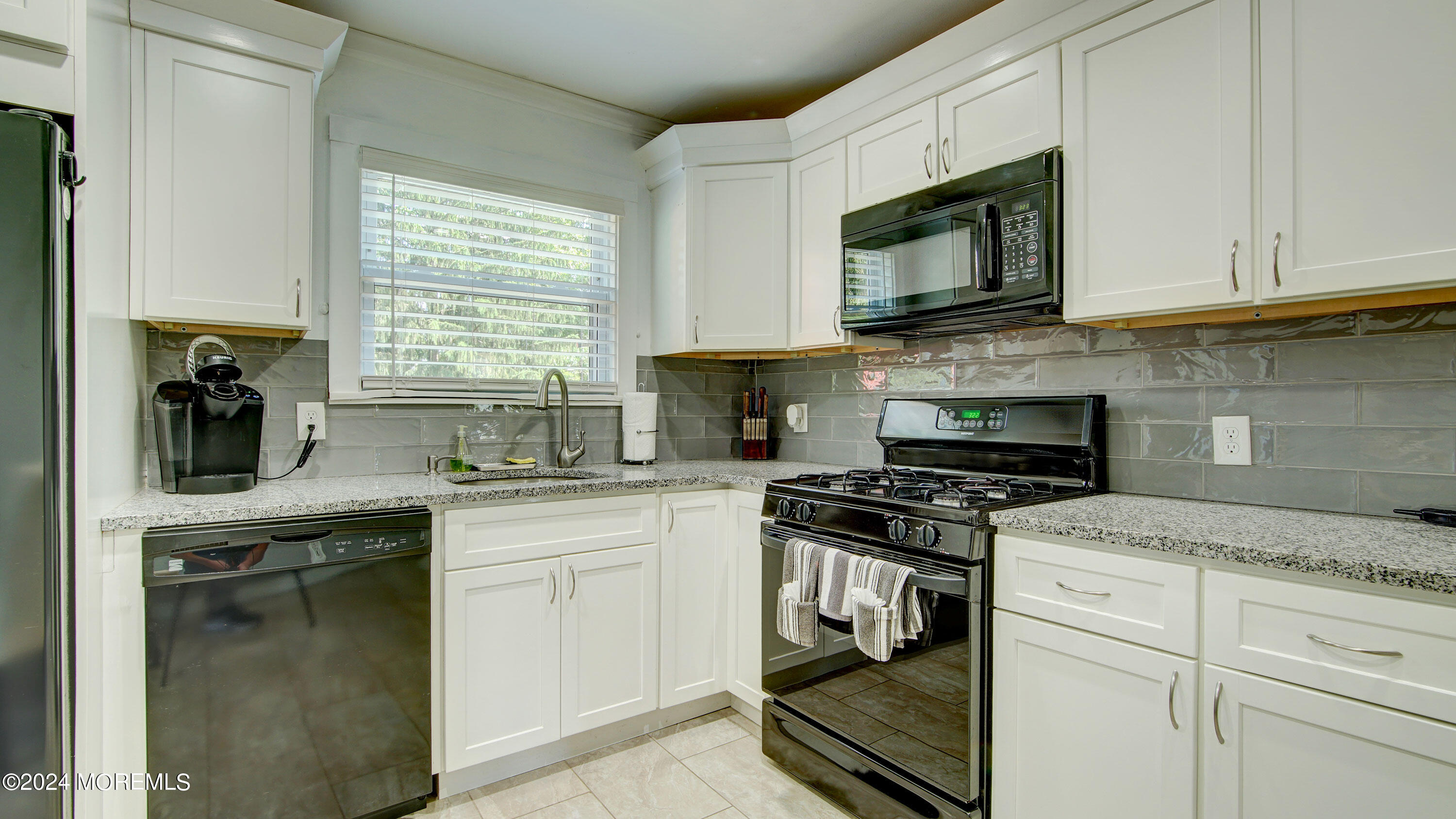 325 Aldrich Road Howell, NJ 07731 - Photo 6 of 19 a kitchen with cabinets stainless steel appliances a sink and a window