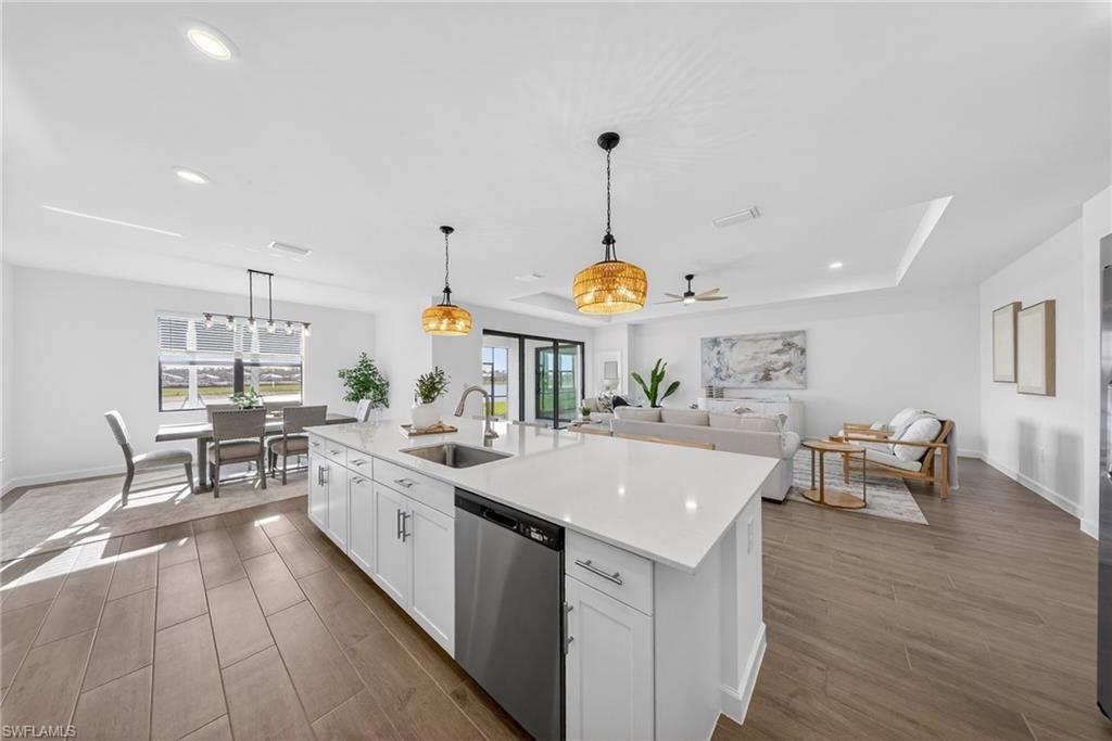 21082 Verawood Loop Estero, FL 33928 - Photo 12 of 50 a large kitchen with a counter space a sink appliances and dining table