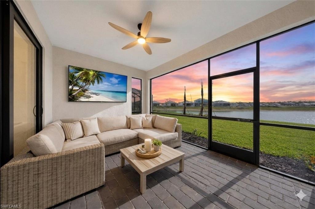 21082 Verawood Loop Estero, FL 33928 - Photo 15 of 50 a living room with furniture and a floor to ceiling window