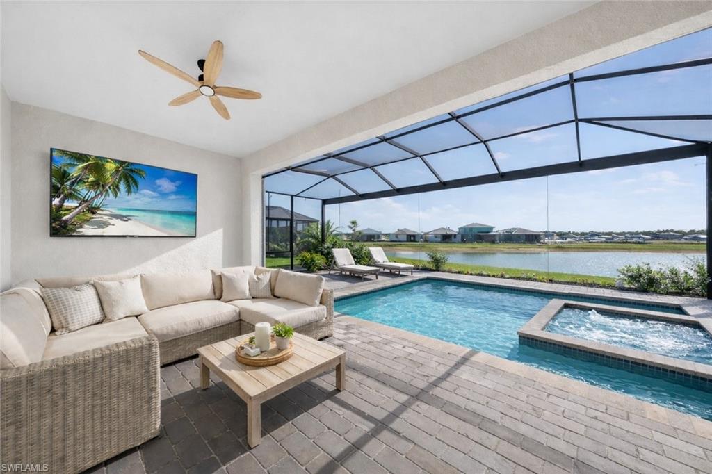 21082 Verawood Loop Estero, FL 33928 - Photo 17 of 50 a living room with furniture and a floor to ceiling window