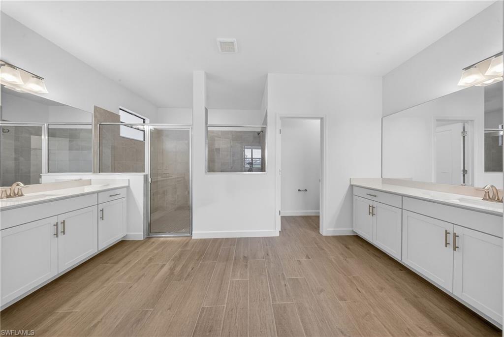 21082 Verawood Loop Estero, FL 33928 - Photo 21 of 50 a large white kitchen with a refrigerator a sink dishwasher with a large mirror next to a window