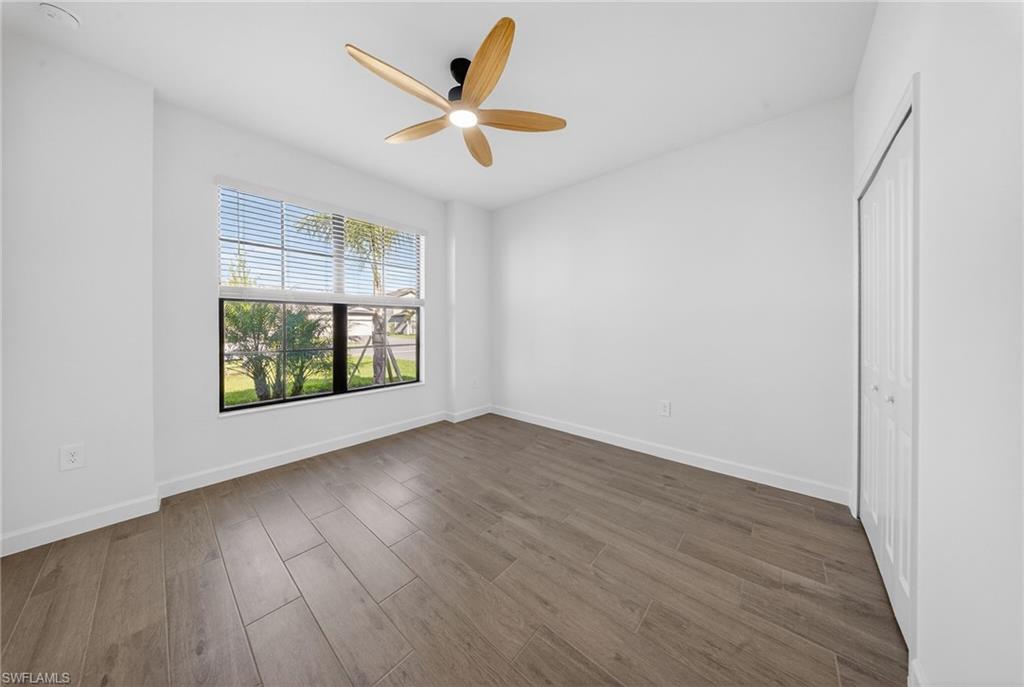 21082 Verawood Loop Estero, FL 33928 - Photo 26 of 50 an empty room with wooden floor and windows