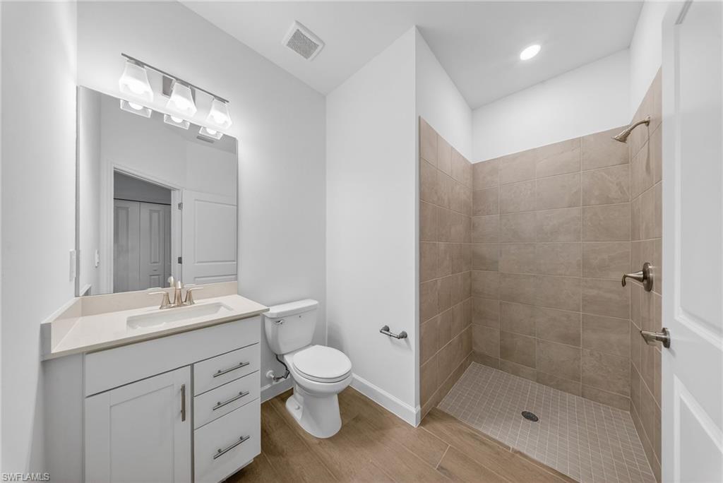 21082 Verawood Loop Estero, FL 33928 - Photo 29 of 50 a bathroom with a sink toilet and shower