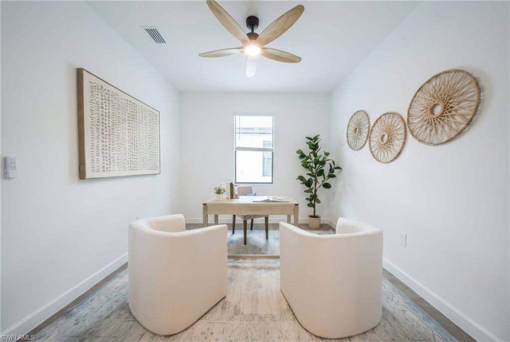 21082 Verawood Loop Estero, FL 33928 - Photo 30 of 50 a living room with couches a table and a potted plant