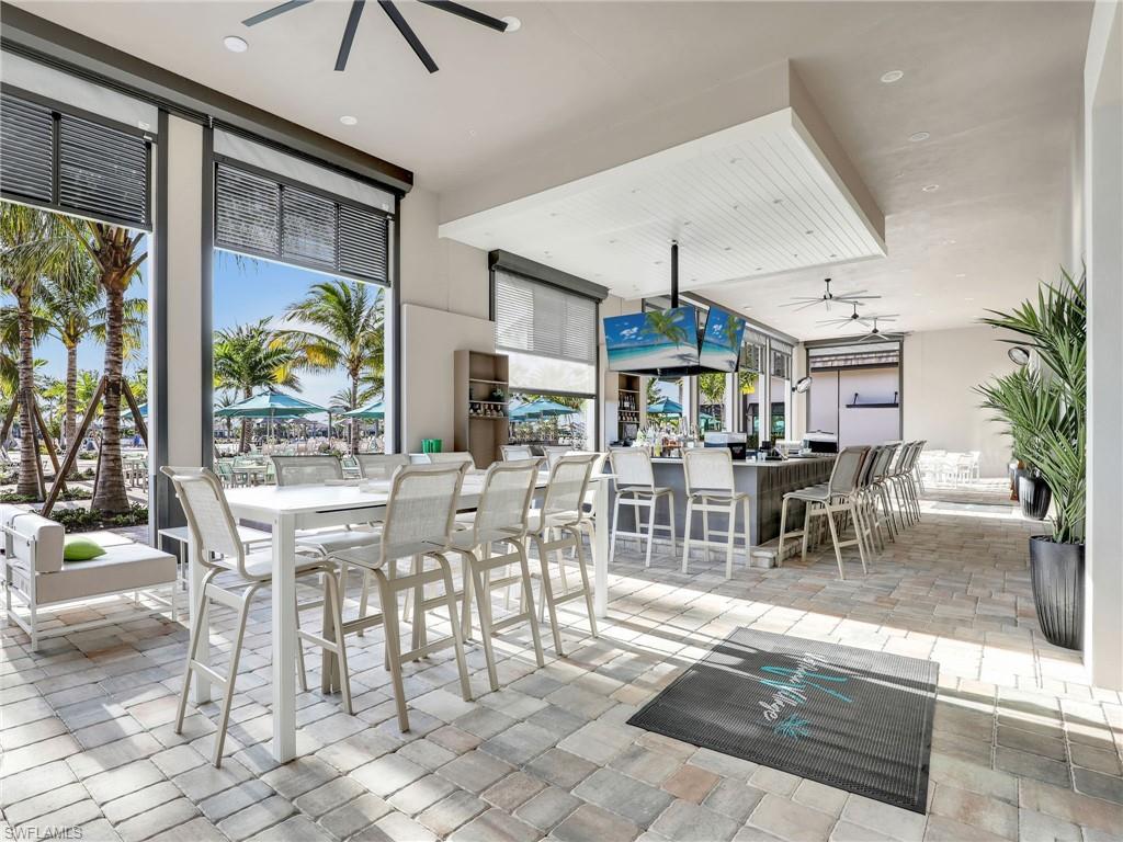 21082 Verawood Loop Estero, FL 33928 - Photo 45 of 50 a dining room with furniture a floor to ceiling window and a table