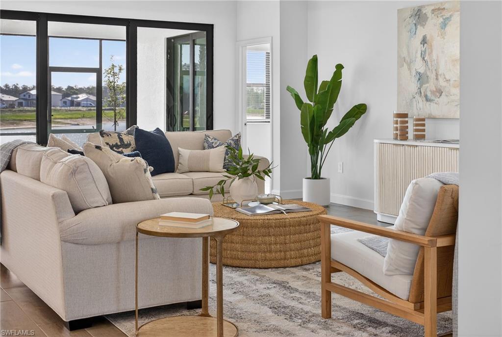 21082 Verawood Loop Estero, FL 33928 - Photo 6 of 50 a living room with furniture a potted plant and a wooden floor