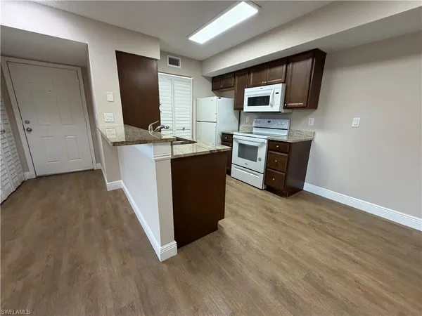 a view of kitchen with microwave stove refrigerator and microwave