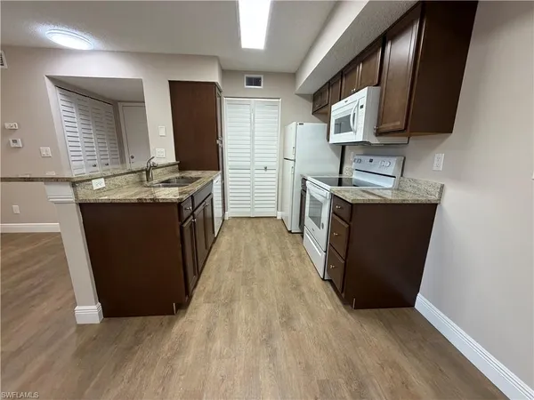 a kitchen with stainless steel appliances granite countertop a stove and a sink