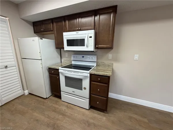 a kitchen with a microwave and a refrigerator