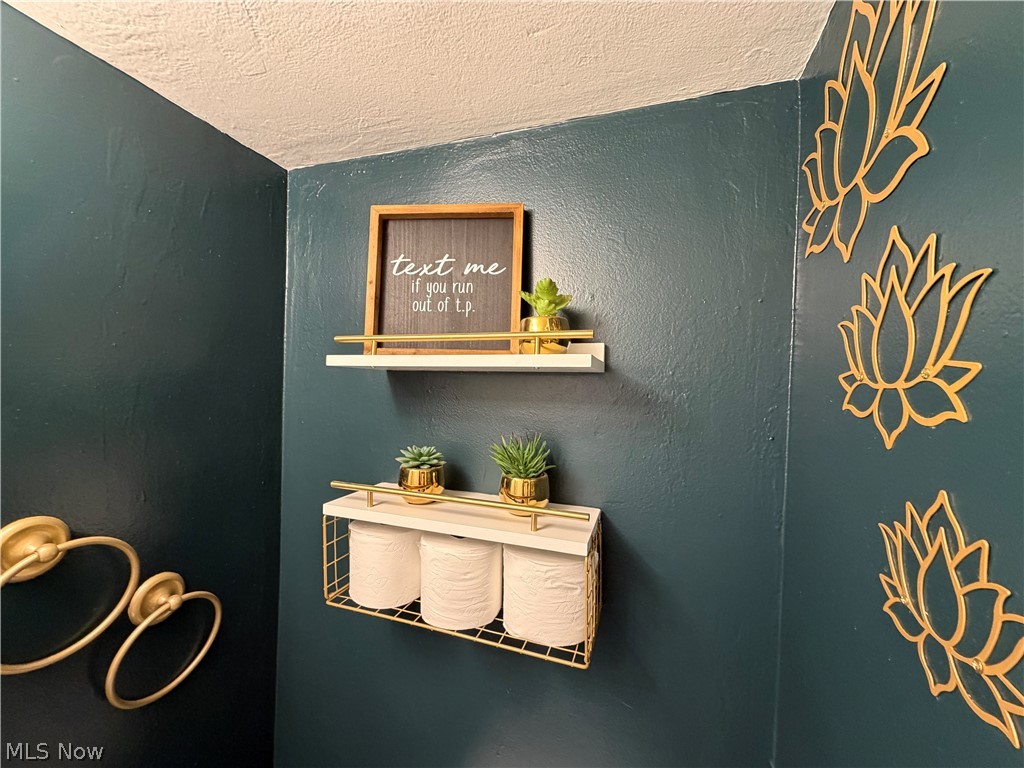 3714 Avalon Road Shaker Heights, OH 44120 - Photo 46 of 46 Dark teal walls with gold-toned wall decor and wall-mounted shelving