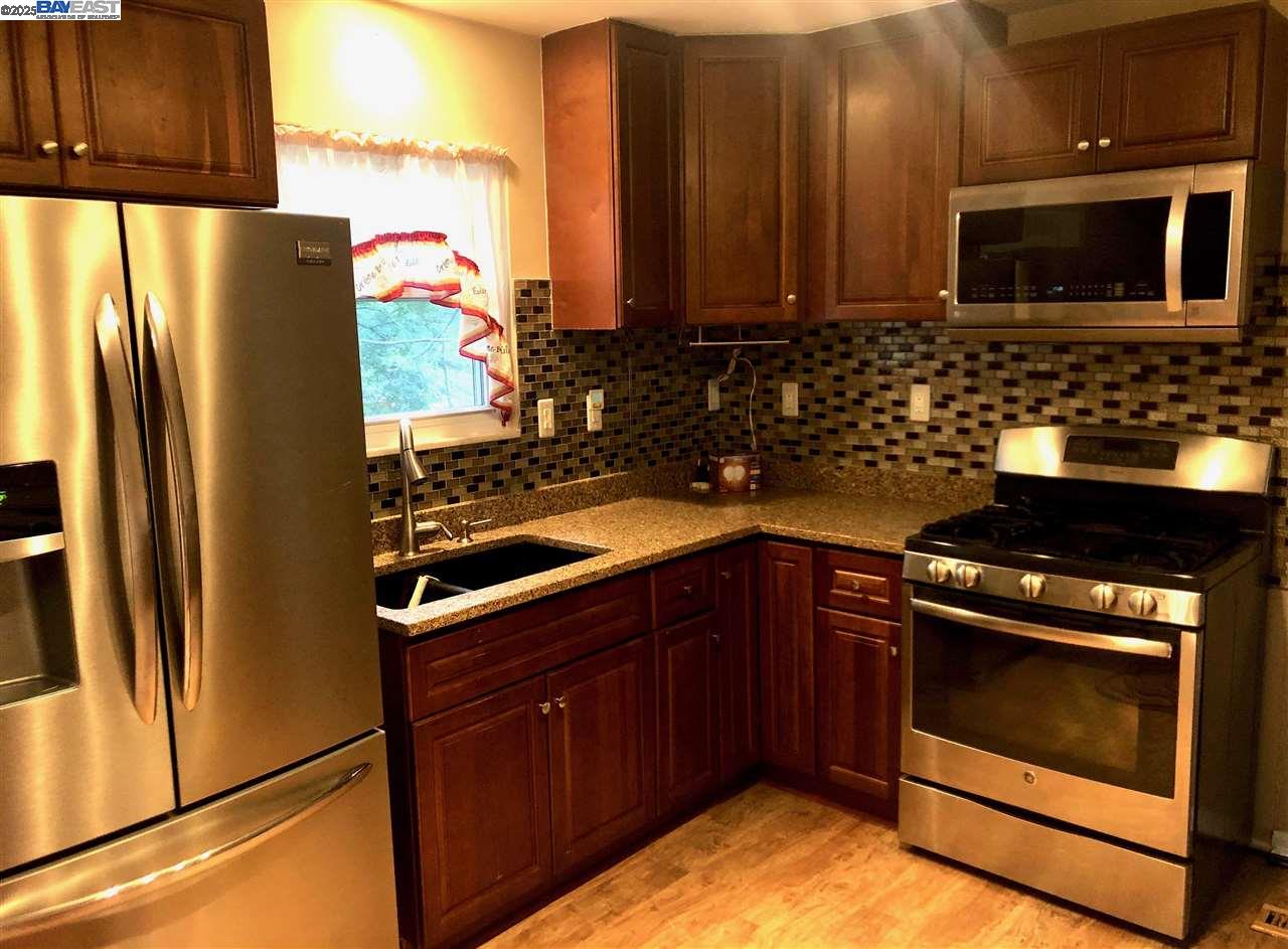 3324 Dale Drive Imperial, MO 63052 - Photo 5 of 14 a kitchen with granite countertop a refrigerator stove and microwave