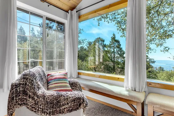 a living room with a large window and a table