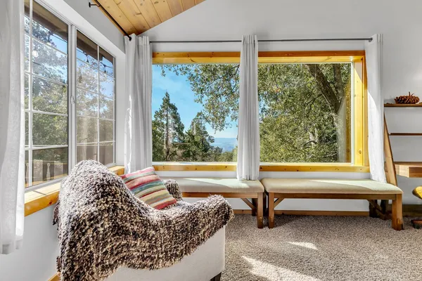 a living room filled with furniture and a large window