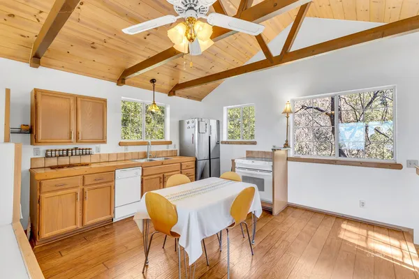a large kitchen with a table and chairs