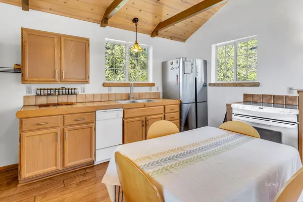 a kitchen with a sink stove and refrigerator