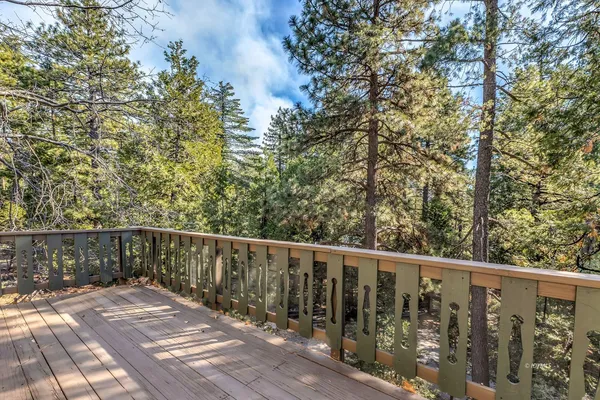 a balcony with wooden floor and fence
