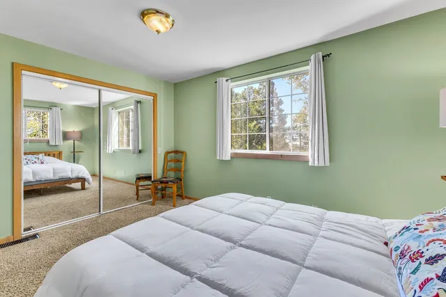 a bedroom with a bed and a lamp on table