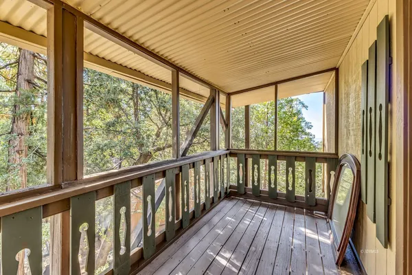 a view of a porch with wooden floor