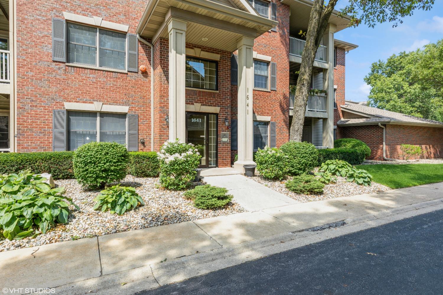 1641 White Oak Circle, Unit 2D Munster, IN 46321 - Photo 1 of 1 front view of a brick house with a small yard