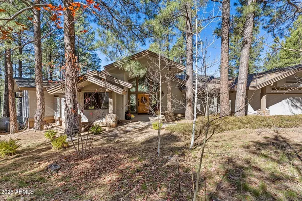 a view of a house with a yard covered in snow