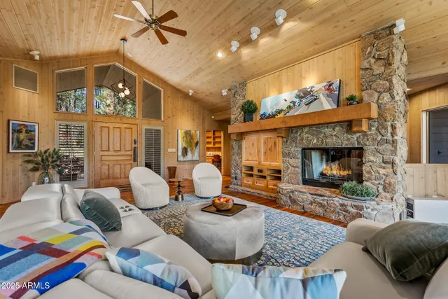 a living room with furniture and a floor to ceiling window
