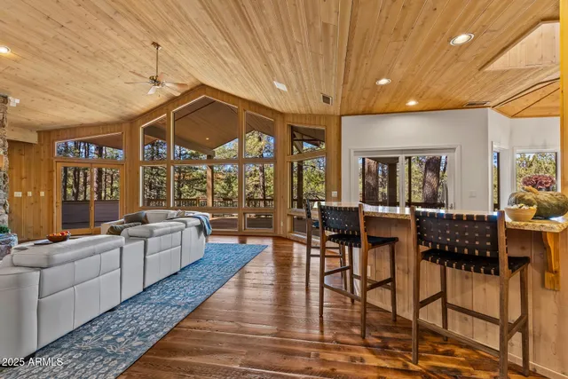 a kitchen that has a lot of cabinets stainless steel appliances and a counter top space