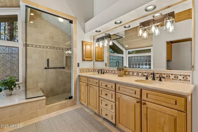 a bathroom with a tub sink and mirror