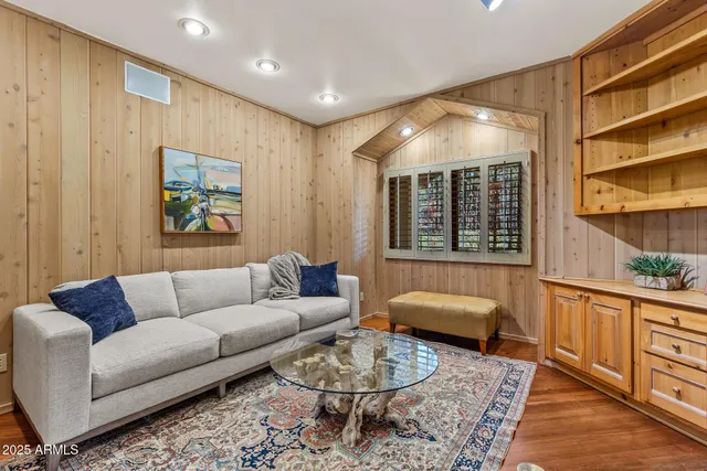 a room with stainless steel appliances kitchen island granite countertop a refrigerator and a sink