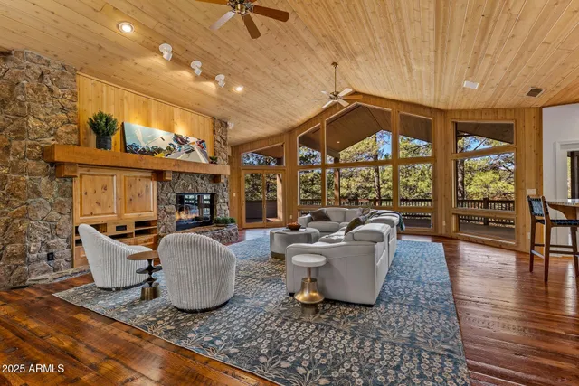 a living room with patio furniture and a floor to ceiling window