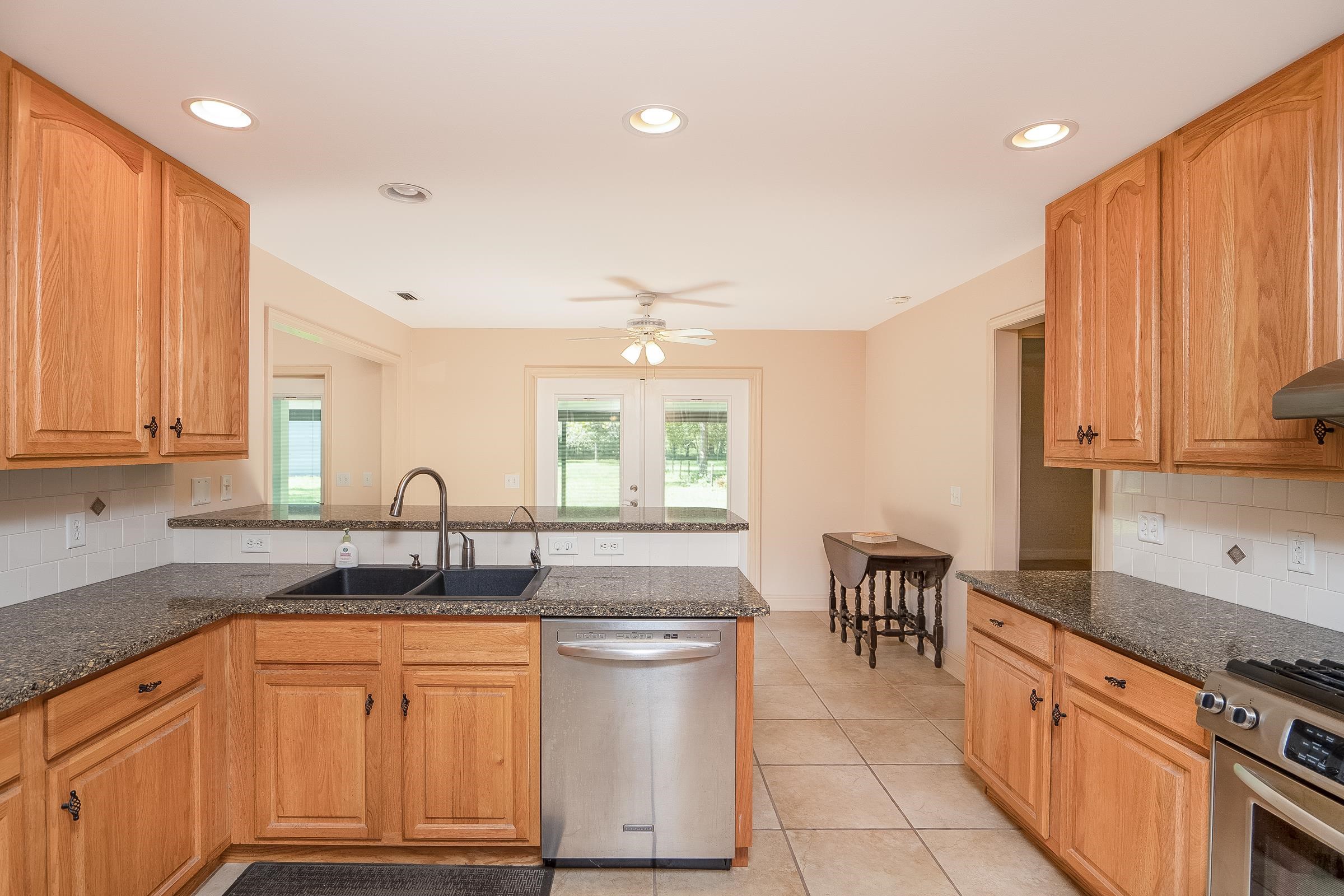 5035 Scaff Road St. Augustine, FL 32092 - Photo 4 of 56 a kitchen with stainless steel appliances granite countertop a sink stove and cabinets