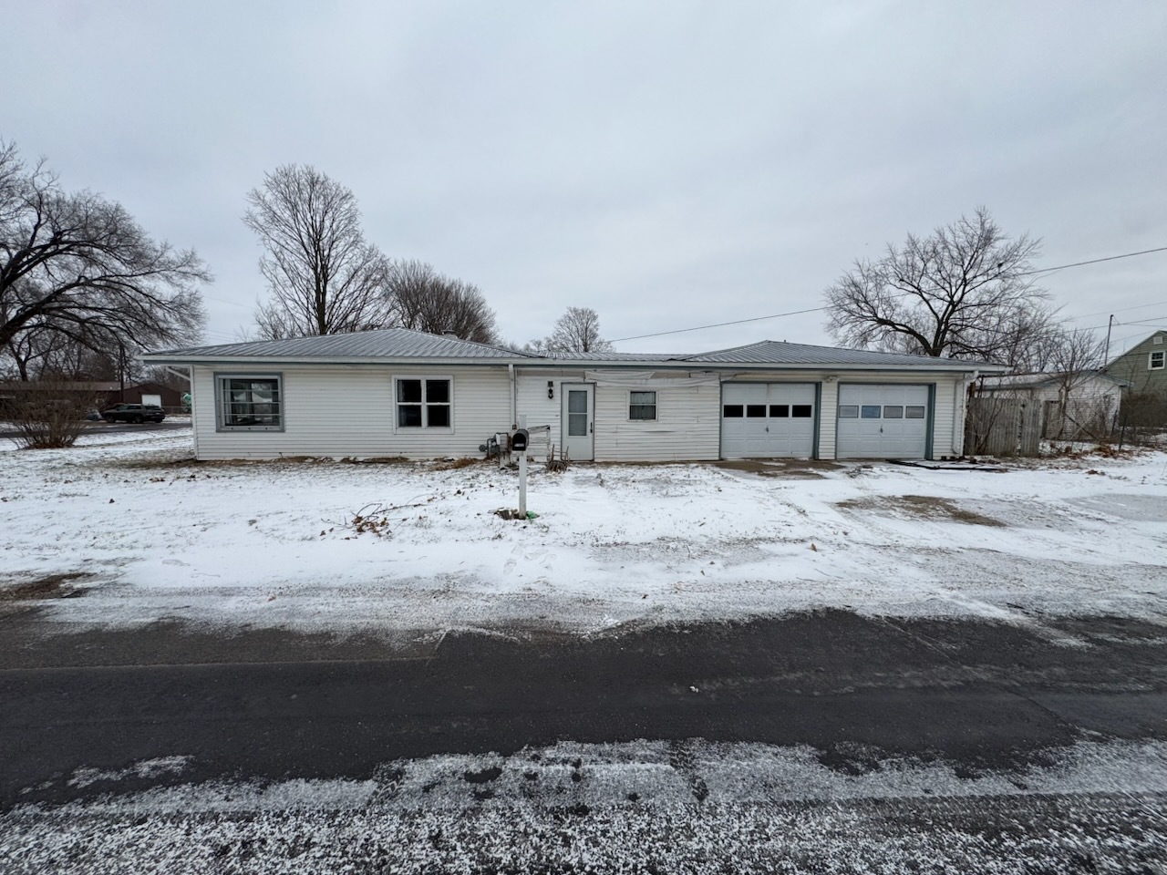 2102 French Street Rock Falls, IL 61071 - Photo 2 of 10 a front view of a house with a dirt yard and a large tree