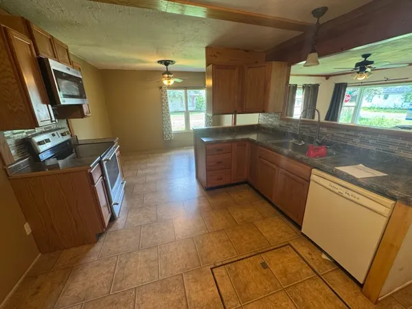 a kitchen with stainless steel appliances granite countertop a sink and a stove