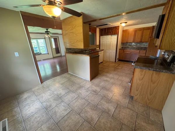 a kitchen with stainless steel appliances a refrigerator and microwave