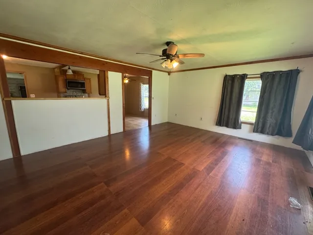 wooden floor in an empty room with a window